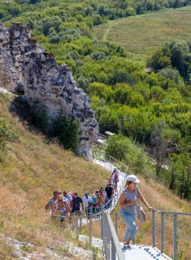 Divnogorye, Russia - September 9, 2018: People climb the plateau of the natural reserve Divnogorye, Voronezh region clipart
