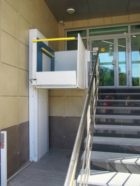 Kaluga, Russia - July 12, 2014: Lift for the disabled at the entrance to the building clipart