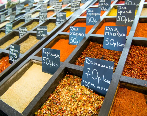 Rows of containers with spices at the grocery market