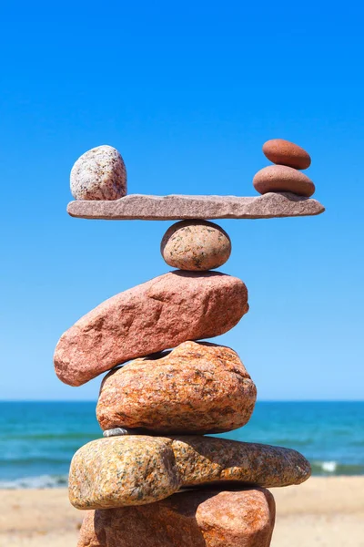 Balance stones against the sea. The concept of work-life balance. Rock zen in the form of scales