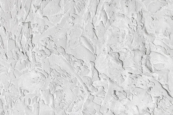 Wall with rough textured plaster. White background image, coarse, grainy texture