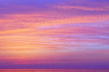 Gün batımından sonra denizin üzerinde fantastik pembe bulutlar. Yumuşak odak