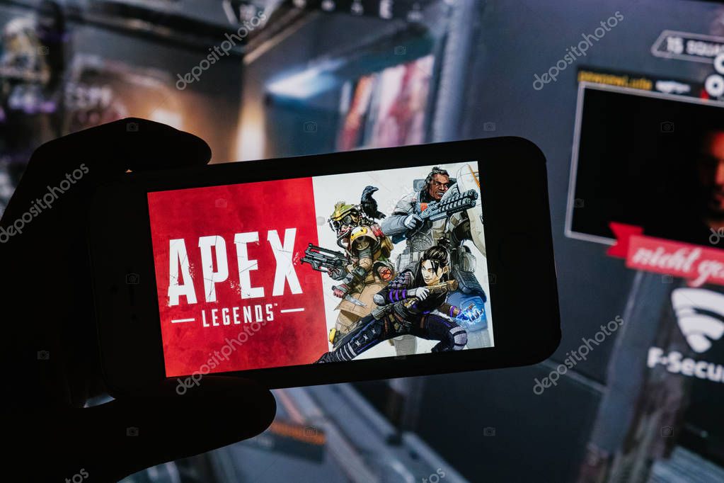 Apex Legends logo is displayed on mobile phone hold by a young boy who plays mobile games