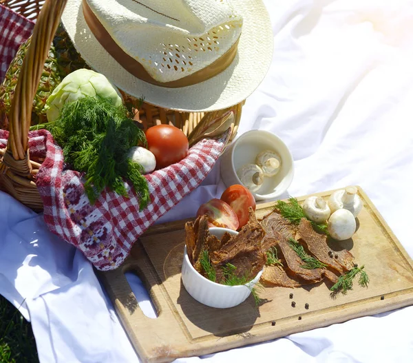 Picnic at the park on the grass: healthy food and accessories, top view