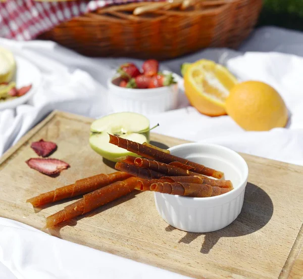 Picnic at the park on the grass: healthy food and accessories, top view