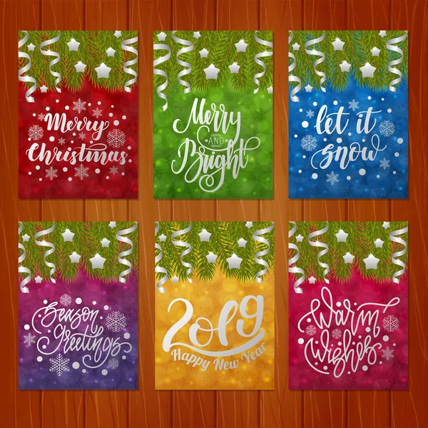 Set of christmas greeting cards with hand written lettering on colorful bokeh backgrounds with Christmas tree branches. — Stock Vector