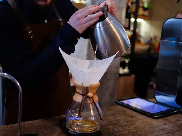 Barista makes coffee filter