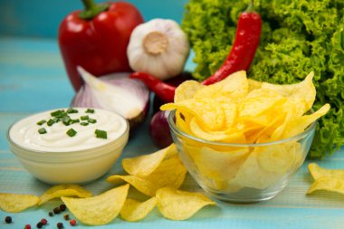 Patates cipsi kase mavi ahşap arka plan üzerinde