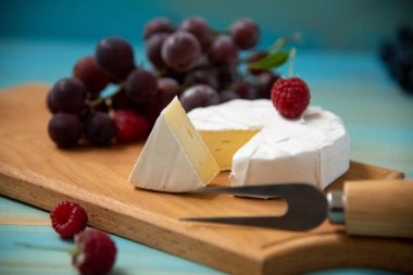 Camembert veya brie mavi ahşap arka plan üzerinde peynir