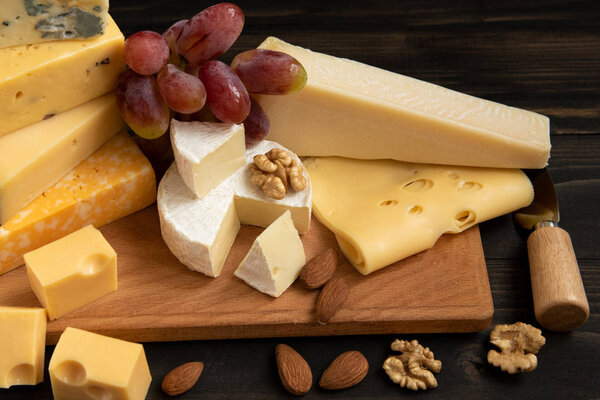 Various types of cheese on a rustic table