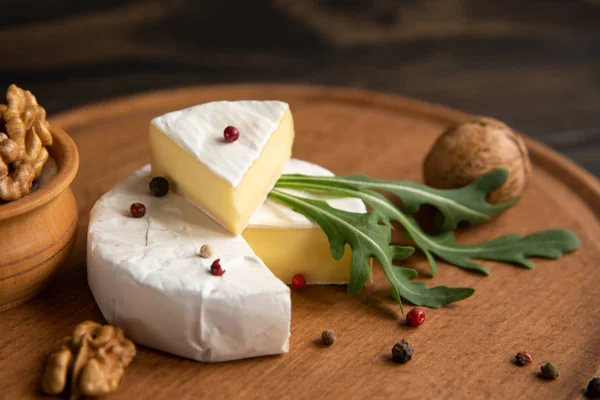 Cheese camembert or brie with walnuts and arugula