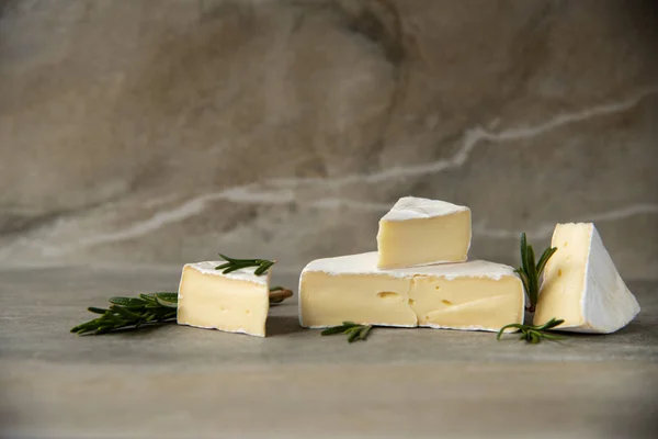 Cheese camembert or brie with fresh rosemary