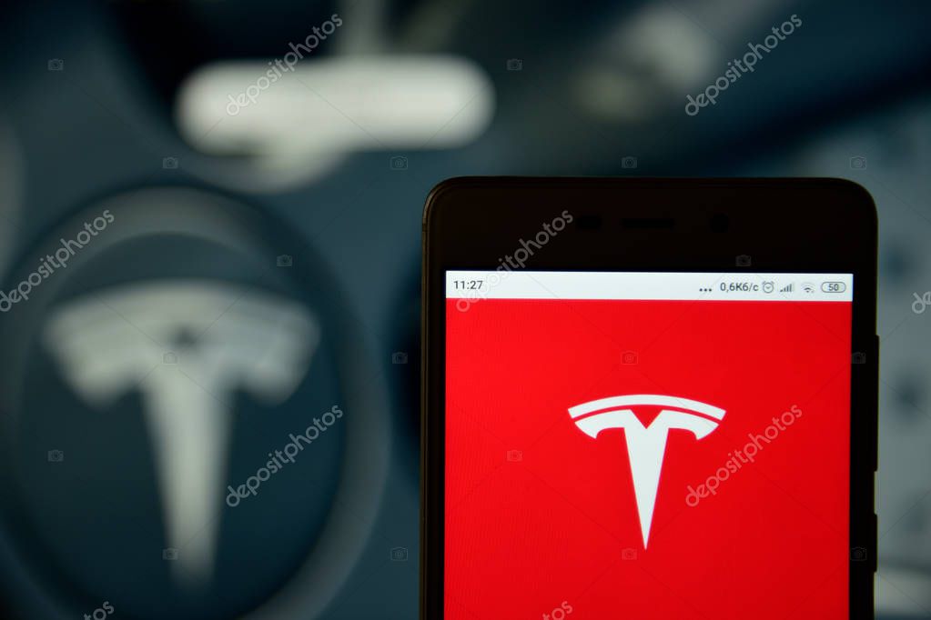 Ivano-Frankivsk, Ukraine - May 13, 2019: Tesla Motors logo is seen on an smartphone over website. Tesla logo is displayed on the screen of a mobile device.