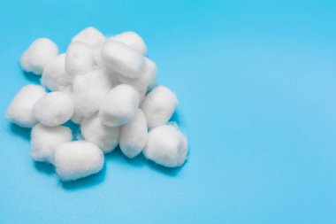 Cotton wool on blue background, Delicate soft cotton wool background, with copy space. clipart