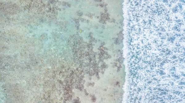 Aerial top view of waves ocean and coral reefs in Indean Ocean, Maldives Island