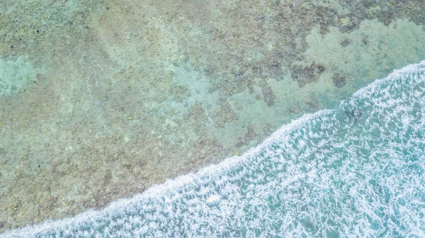 Aerial top view of waves ocean and coral reefs in Indean Ocean, Maldives Island