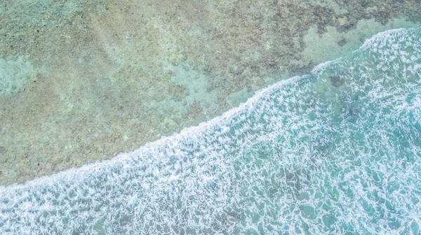 Aerial top view of waves ocean and coral reefs in Indean Ocean, Maldives Island