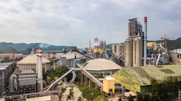 Aerial view cement plant factory manufacturing, Cement factory machinery on a blue sky background.