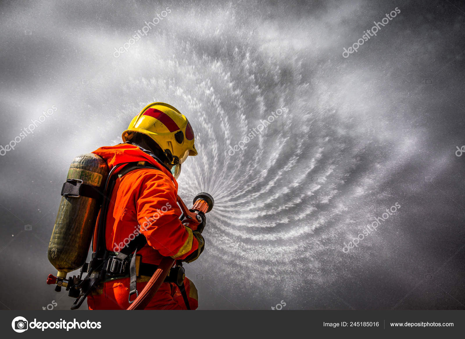 firefighter fighting fire with hose