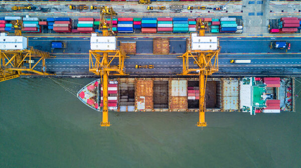 Container ship carrying container for import and export, Aerial view business logistic and freight transportation by ship in open sea.