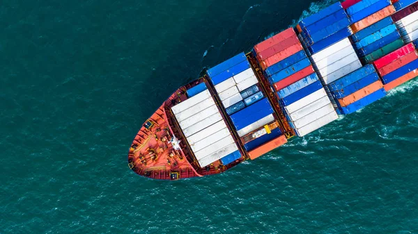 Aerial view cargo container ship carrying container for import and export, business logistic and freight transportation by ship in open sea.