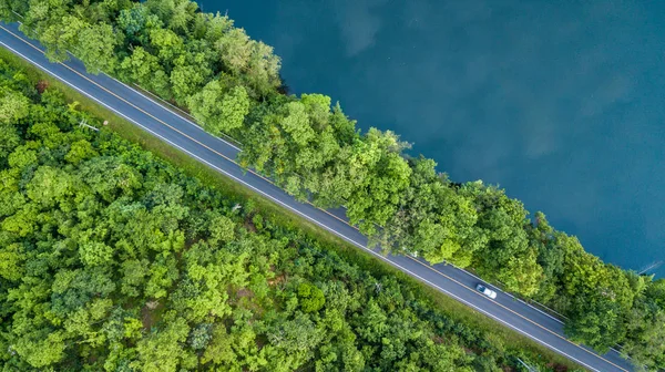 Aerial top view road track with car and river, around the tree and forest, Aerial view of the road through river and forest.