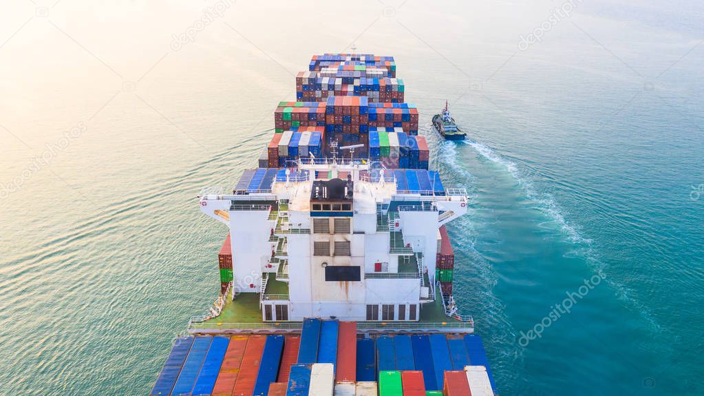 Container ship arriving in port, container ship and tug boat going to sea port, logistic business import export shipping and transportation, Aerial view.