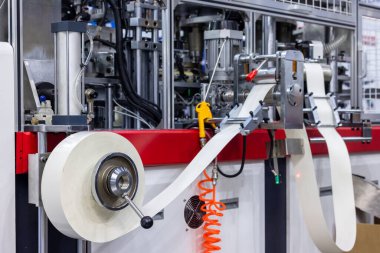 Paper drink cup making machine, Paper cup machine engaged in industrial production, Paper cup on automatic manufacturing process in factory.