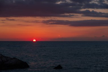 Beach çevresinde Petra tou Romiou, Paphos, Kıbrıs için güzel gün batımı manzarası. Yunan mitolojisinde Afrodit'ın Doğum yeri olarak kabul edilir.