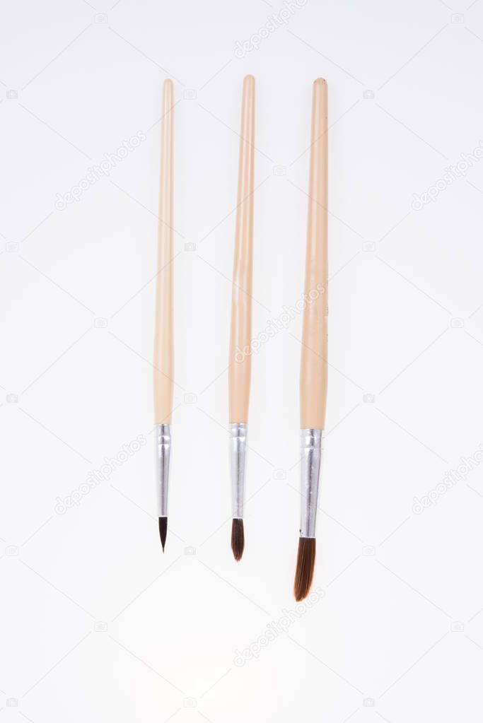 Painting brushes. Drawing tools, paint brushes on white background, copy space, top view
