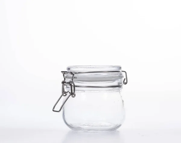 Frasco de vidro com tampa sobre fundo branco — Fotografia de Stock