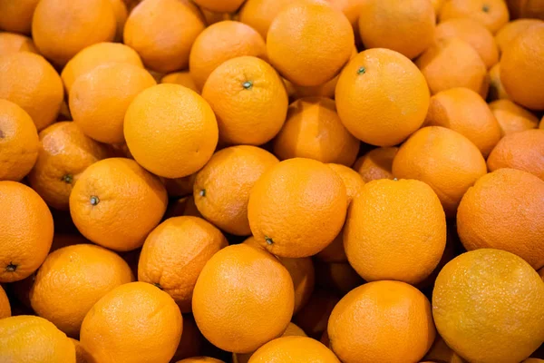 Lots of fresh mandarin oranges at market place. Oranges background