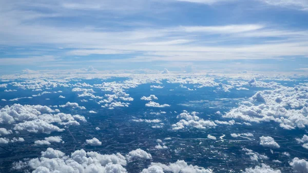 Aerial view landscape of Bangkok city in Thailand with cloud from aerial view airplane.