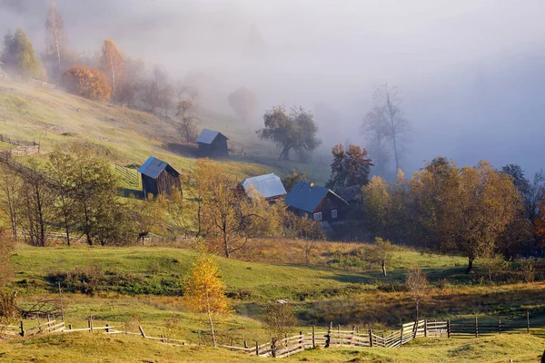 Sisli sonbahar sabahı yukarıda geleneksel Romen cottages, Bucovina - Romanya