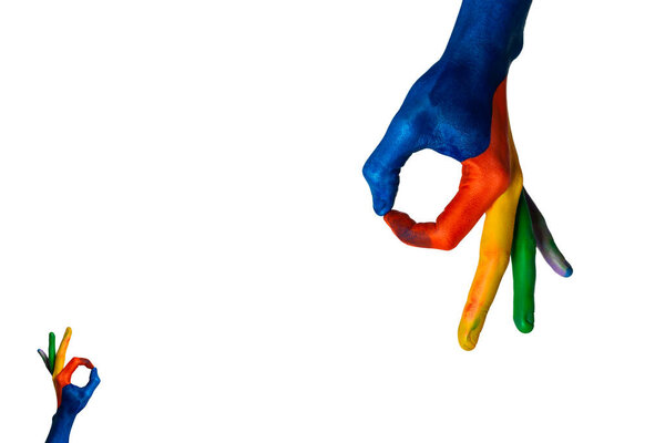 Stock photo of water painted hands making gestures on a white background.