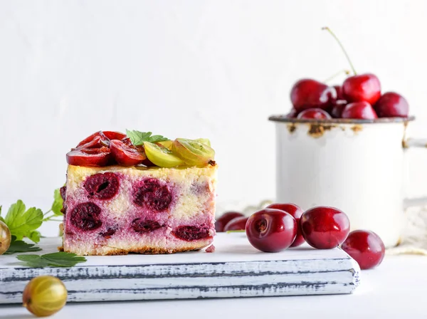 stock image a piece of a pie from berries of a cherry and cottage cheese, it is decorated by fresh berries, close up