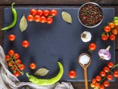 Картина, постер, плакат, фотообои "ripe red cherry tomatoes, chili and spices on a black background, copy space", артикул 207403464