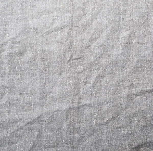 fragment of gray linen fabric, crumpled texture, full frame