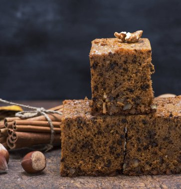 Üç pişmiş pasta sünger kahverengi ahşap masa, fındık ile yakın çekim