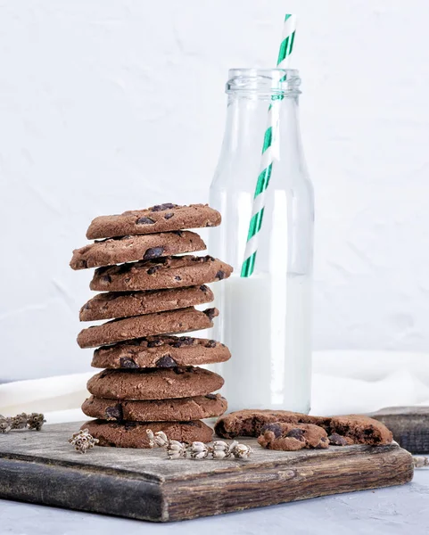 Stack Chocolate Chip Cookies Glass Bottle Milk Brown Wooden Board — Stock Photo, Image