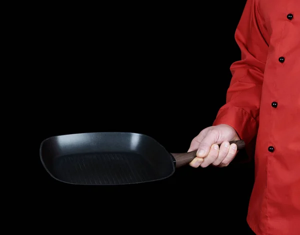 Cozinhe Uniforme Vermelho Segurando Uma Frigideira Preta Quadrada Vazia Fundo — Fotografia de Stock