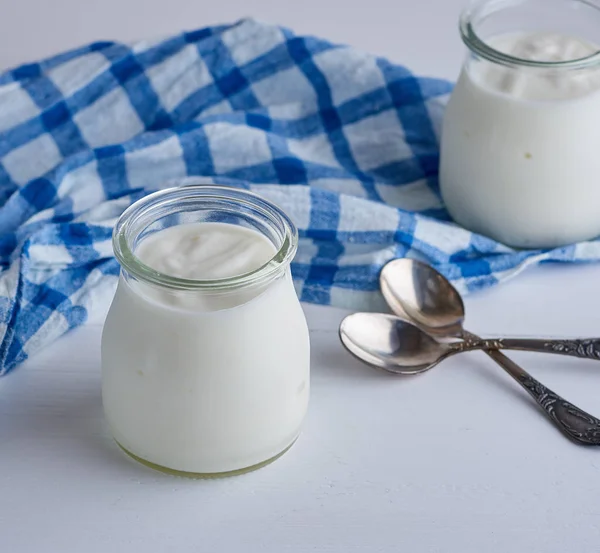 Glazen Potten Met Zelfgemaakte Yoghurt Een Witte Houten Bord Bovenaanzicht — Stockfoto