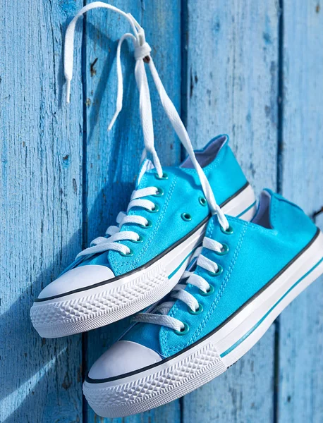 挂在钉子上的一双蓝色纺织运动鞋 — 图库照片