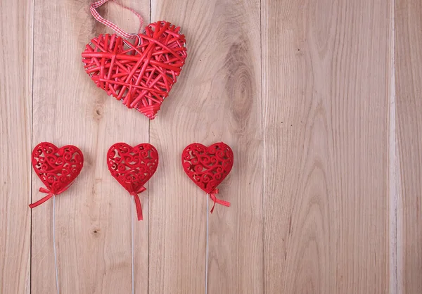 Red hearts on a wooden background of oak boards — Stock Photo, Image