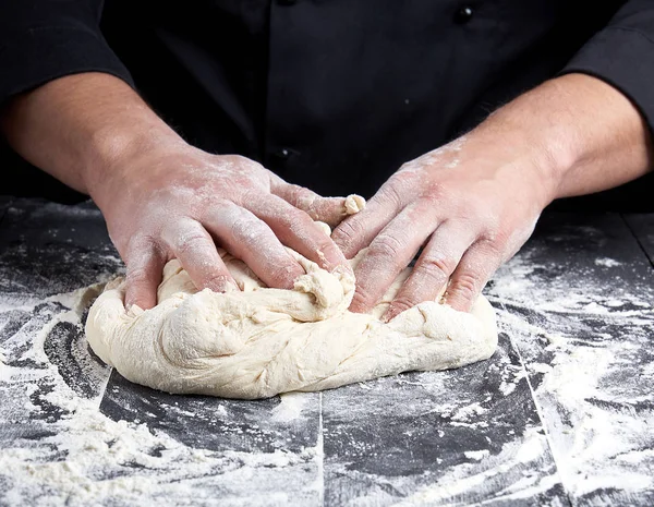 Baker kneads white wheat flour dough — Stock Photo, Image