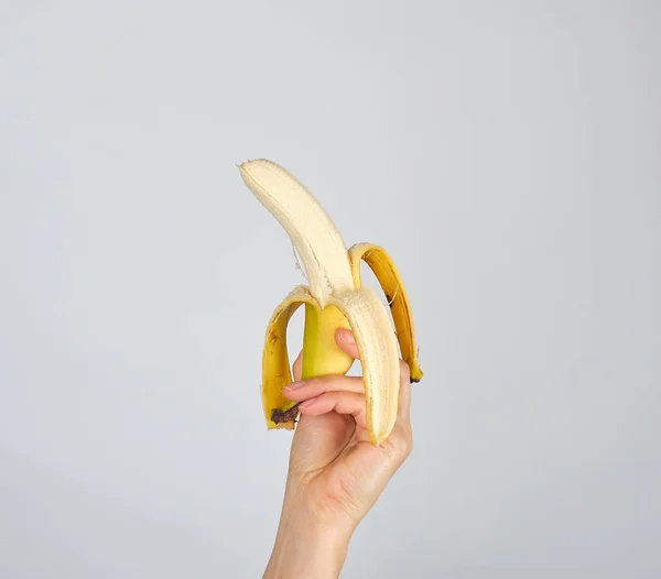 Peeled fresh banana in female hand — Stock Photo, Image