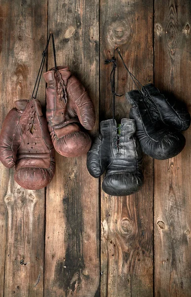 Due paia di guanti da boxe vintage in pelle appesi a un chiodo — Foto Stock