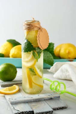 bir cam şişe de meşrubat limonata ve olgun taze limon