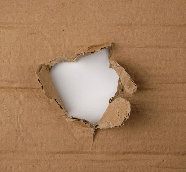 Brown sheet of paper with a hole, full frame Stock Photo