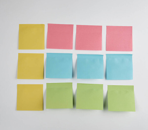 pink, blue, green  paper stickers pasted on white  background